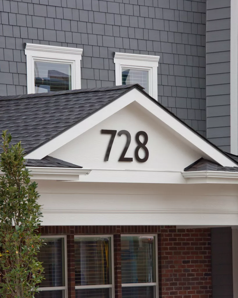 Close up of address 728 on pitch of roof.